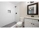 Bathroom featuring a tiled shower with niche, gray flooring, and a granite countertop vanity at 705 Country Park Se Dr, Smyrna, GA 30080