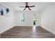 A bedroom featuring gray wood flooring, white walls, a ceiling fan, and a glass door at 705 Country Park Se Dr, Smyrna, GA 30080