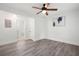 This bedroom features gray wood flooring, a modern ceiling fan, and a door to the bathroom at 705 Country Park Se Dr, Smyrna, GA 30080
