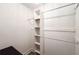 The walk-in closet includes white shelving and hanging rods for maximum storage at 705 Country Park Se Dr, Smyrna, GA 30080