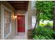 Welcoming condo entrance with a red door, classic trim, and manicured landscaping at 705 Country Park Se Dr, Smyrna, GA 30080