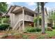 Inviting two-story condo with wood siding, a deck, and lush landscaping at 705 Country Park Se Dr, Smyrna, GA 30080