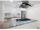 Updated kitchen featuring granite countertops, stainless steel appliances, and a modern range hood at 705 Country Park Se Dr, Smyrna, GA 30080