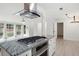 Open kitchen boasts a gas cooktop, granite countertops, and views of the living area with large windows at 705 Country Park Se Dr, Smyrna, GA 30080