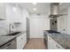 Contemporary kitchen with granite countertops, stainless steel appliances, and sleek white cabinetry at 705 Country Park Se Dr, Smyrna, GA 30080