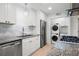 Bright kitchen featuring granite countertops, marble backsplash, and a convenient stackable washer/dryer at 705 Country Park Se Dr, Smyrna, GA 30080