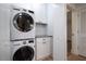 Neat laundry area equipped with a stackable washer and dryer, plus functional cabinet storage at 705 Country Park Se Dr, Smyrna, GA 30080