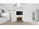 Cozy living area with fireplace, tv, light floors and a view of the kitchen at 705 Country Park Se Dr, Smyrna, GA 30080