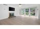 Open living room with fireplace, light floors, and large windows, offering a comfortable space at 705 Country Park Se Dr, Smyrna, GA 30080
