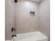 The newly tiled shower features modern fixtures, a built-in niche and a bathtub at 705 Country Park Se Dr, Smyrna, GA 30080