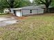 Angled exterior of the gray home showing a driveway and yard at 2135 Wells Se Dr, Smyrna, GA 30080