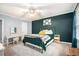 Comfortable bedroom featuring teal accent wall, stylish decor, neutral carpet, and ceiling fan at 2349 Henderson Mill Ne Rd # 2, Atlanta, GA 30345