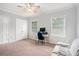 Bedroom featuring neutral carpet, lots of natural light, ceiling fan, and space for an office or seating at 2349 Henderson Mill Ne Rd # 2, Atlanta, GA 30345