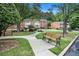 Well-maintained complex with brick buildings, mature trees, sidewalks, and inviting benches at 2349 Henderson Mill Ne Rd # 2, Atlanta, GA 30345