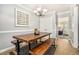 Cozy dining area with stylish table and bench seating, flowing into the adjacent living room at 2349 Henderson Mill Ne Rd # 2, Atlanta, GA 30345