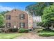Brick home with black shutters, complimented by mature trees and inviting landscaping at 2349 Henderson Mill Ne Rd # 2, Atlanta, GA 30345