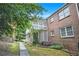 View of a brick house featuring a multi-level deck, enhancing outdoor living, and a well-maintained lawn at 2349 Henderson Mill Ne Rd # 2, Atlanta, GA 30345