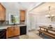 Charming kitchen with wood cabinets, tiled backsplash, and a view into the dining area at 2349 Henderson Mill Ne Rd # 2, Atlanta, GA 30345