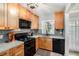 Well-lit kitchen featuring light wood cabinets, black appliances, grey backsplash and speckled countertops at 2349 Henderson Mill Ne Rd # 2, Atlanta, GA 30345