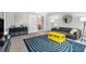 Modern living room featuring neutral walls, stylish rug, and a comfortable gray sofa at 2349 Henderson Mill Ne Rd # 2, Atlanta, GA 30345