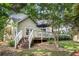 Exterior of home features a back deck, a well-manicured lawn, and mature trees at 2735 Royal Blf, Decatur, GA 30030