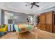 Bright bedroom features a tray ceiling, a large window, and a built-in wooden cabinet at 2735 Royal Blf, Decatur, GA 30030