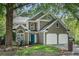Charming home with a two-car garage, landscaped yard, and a welcoming blue front door at 2735 Royal Blf, Decatur, GA 30030