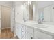 Clean bright bathroom featuring double sinks and a new vanity with sleek finishes at 3055 Kennesaw Nw Dr, Kennesaw, GA 30152