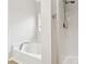 Bright bathroom featuring a soaking tub and stand up shower with modern fixtures at 3055 Kennesaw Nw Dr, Kennesaw, GA 30152