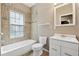 Bathroom featuring tile surround tub, vanity, and a large mirror at 3055 Kennesaw Nw Dr, Kennesaw, GA 30152
