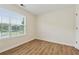 Bright bedroom with hardwood floors and a large window with a view to the outdoors at 3055 Kennesaw Nw Dr, Kennesaw, GA 30152