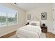 Cozy staged bedroom featuring a plush bed, bedside tables, and a large window at 3055 Kennesaw Nw Dr, Kennesaw, GA 30152