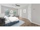 Bright bedroom featuring new wood flooring, ceiling fan, ample light, and modern decor at 3055 Kennesaw Nw Dr, Kennesaw, GA 30152