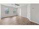 Spacious bedroom featuring new wood flooring, ceiling fan, ample light, and neutral paint at 3055 Kennesaw Nw Dr, Kennesaw, GA 30152