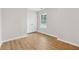 Bright bedroom with hardwood floors and a large window overlooking nature at 3055 Kennesaw Nw Dr, Kennesaw, GA 30152