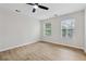 Spacious bedroom featuring new wood flooring, ceiling fan, and windows offering a bright airy feel at 3055 Kennesaw Nw Dr, Kennesaw, GA 30152