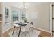 Bright dining area with a modern table, white chairs, and large windows providing ample natural light at 3055 Kennesaw Nw Dr, Kennesaw, GA 30152