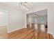 Open-concept dining room with hardwood floors, modern lighting, and seamless flow to the living area at 3055 Kennesaw Nw Dr, Kennesaw, GA 30152