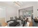Elegant dining area with modern table setting, hardwood floors, and a view to the comfortable living room at 3055 Kennesaw Nw Dr, Kennesaw, GA 30152