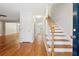 Bright entryway with hardwood floors, a staircase, and a white door leading to the living areas at 3055 Kennesaw Nw Dr, Kennesaw, GA 30152