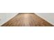 New wood flooring installed in a hallway with crisp white trim, a clean and seamless look at 3055 Kennesaw Nw Dr, Kennesaw, GA 30152
