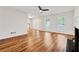Inviting living room with hardwood floors, fireplace, ample natural light, and an open view of the entryway at 3055 Kennesaw Nw Dr, Kennesaw, GA 30152