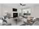 Comfortable living room featuring a fireplace, ceiling fan, hardwood floors, and modern staging at 3055 Kennesaw Nw Dr, Kennesaw, GA 30152