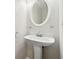 Clean powder room featuring a pedestal sink, mirror, and towel rack at 3055 Kennesaw Nw Dr, Kennesaw, GA 30152