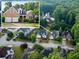 Aerial view of a brick home surrounded by lush greenery in a residential neighborhood at 3082 Monarch Pine Dr, Peachtree Corners, GA 30071