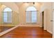 Bedroom featuring hardwood floors, large window, and wardrobe mirror at 3082 Monarch Pine Dr, Peachtree Corners, GA 30071