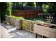 A raised wooden deck with wooden railing, barrel, and a swing set in background at 3082 Monarch Pine Dr, Peachtree Corners, GA 30071