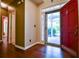 Bright foyer with red door, wood floors, and views of the landscaped front yard at 3082 Monarch Pine Dr, Peachtree Corners, GA 30071
