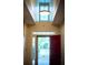 Inviting foyer with a bright red door and an interesting overhead light fixture at 3082 Monarch Pine Dr, Peachtree Corners, GA 30071