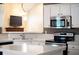Close-up of a bright kitchen with granite counters and stainless steel microwave and oven at 3082 Monarch Pine Dr, Peachtree Corners, GA 30071